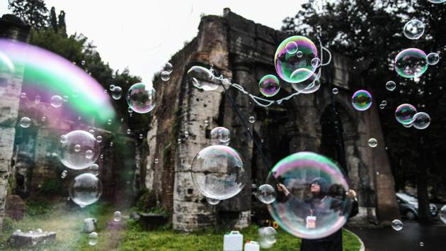 A man blows soap bubbles for tourists in Rome, Italy. (Vincenzo Pinto / AFP) 