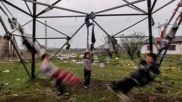 Roma children swing on tied clothes near their shelter at a Roma Camp in the village of Plemetina, near Pristina in Kosovo, during the International Roma Day marked around Europe to celebrate Romani culture and raise awareness of the situation of Roma. (Armend Nimani / AFP) 