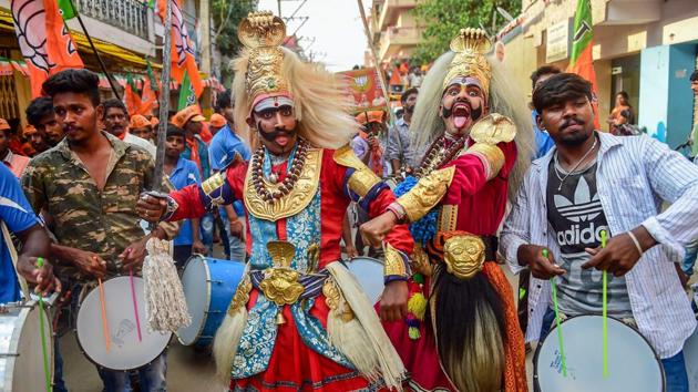 Folk artists perform during BJP National President Amit Shah’ roadshow for the party candidate B N Bachegowda from Chikkaballapur constituency, ahead of Lok Sabha election 2019 in Bengaluru, Karnataka. (Shailendra Bhokak / PTI) Folk artists perform during BJP National President Amit Shah’ roadshow for the party candidate B N Bachegowda from Chikkaballapur constituency, ahead of Lok Sabha election 2019 in Bengaluru, Karnataka. (Shailendra Bhokak / PTI)