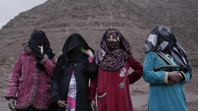 (L-R) The first female Bedouin guides, Selima, Umm Yasser, Umm Soliman, and Aicha. Umm Yasser is breaking new ground among the Bedouin as one of four women from the community who for the first time are working as tour guides. “It is against our culture, but women need jobs,” the 47-year-old said. “People will make fun of us, but I don’t care. I’m a strong woman.” (Nariman El-Mofty / AP) 