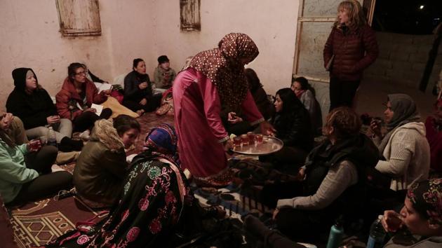 Umm Yasser offers tea during a women’s only circle of tourists and Bedouin from the Hamada tribe. In the evening, the group returned to the Hamada tribe’s village. The women sat on the floor of Umm Yasser’s home and the tourists asked the guide about life in the village, marriage and divorce. (Nariman El-Mofty / AP) 