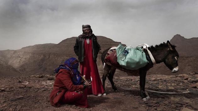 Umm Yasser looks at Umm Soliman as she plays the flute. Umm Yasser said she started hiking when she was a child and knows the mountains and the valley by heart. She convinced the families of the others to allow them to work. “We need money to help support our families for basic necessities,” Umm Yasser said. “We need blankets, clothes for the children, washing machines, fridges, books for school.” (Nariman El-Mofty / AP) 