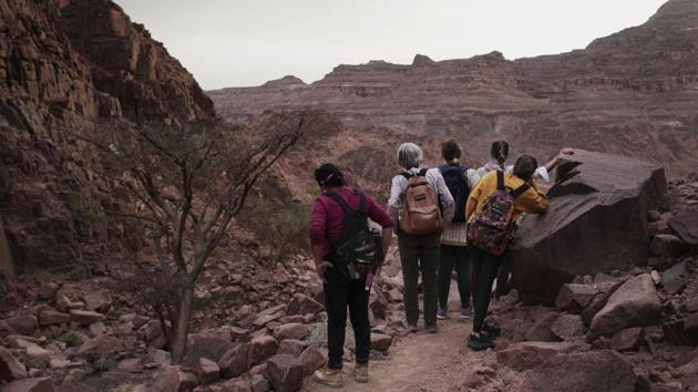The tourists can only be women, and the tours can’t go overnight. Each day before the sun sets, the group returns to the Hamada’s home village in Wadi Sahu, a narrow desert valley. The organizers also urge the tourists to photograph the guides only when they are wearing a full veil over the face that covers even the eyes with mesh. Umm Yasser was the first to join. (Nariman El-Mofty / AP) 