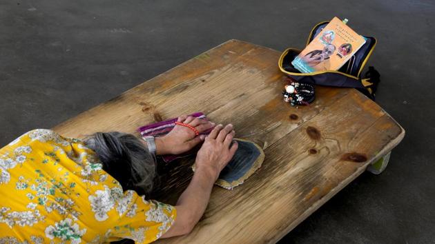 An exile Tibetan woman prays as she prostrates in front of a portrait of Buddhist spiritual leader the Dalai Lama in Dharmsala, Himachal Pradesh. The Dalai Lama was hospitalised briefly in Delhi with chest infection. (Ashwini Bhatia / AP) An exile Tibetan woman prays as she prostrates in front of a portrait of Buddhist spiritual leader the Dalai Lama in Dharmsala, Himachal Pradesh. The Dalai Lama was hospitalised briefly in Delhi with chest infection. (Ashwini Bhatia / AP)