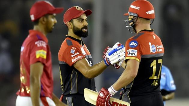 Royal Challengers Bangalore (RCB) batsman Virat Kohli celebrates his fifty with AB de Villiers. (PTI)