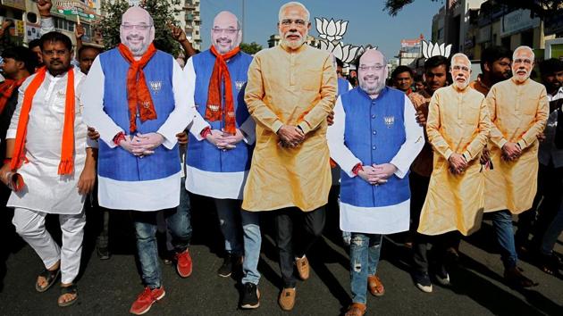 Supporter of the ruling Bharatiya Janata Party (BJP) wearing cut-outs of Prime Minister Narendra Modi and the party president Amit Shah walk during an election campaign in Ahmedabad, Gujarat. (Amit Dave / REUTERS) Supporter of the ruling Bharatiya Janata Party (BJP) wearing cut-outs of Prime Minister Narendra Modi and the party president Amit Shah walk during an election campaign in Ahmedabad, Gujarat. (Amit Dave / REUTERS)
