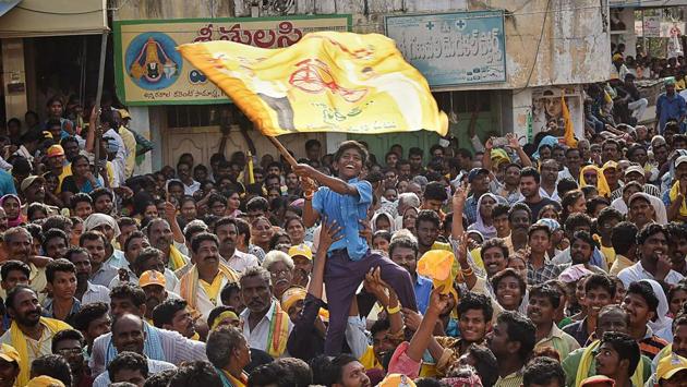 A young supporter of Telugu Desam Party (TDP) waves a flag as N. Chandrababu Naidu, chief minister of Andhra Pradesh state and former Prime Minister, H.D. Deve Gowda (unseen) address a public rally in Krishna district of Andhra Pradesh. (AFP) A young supporter of Telugu Desam Party (TDP) waves a flag as N. Chandrababu Naidu, chief minister of Andhra Pradesh state and former Prime Minister, H.D. Deve Gowda (unseen) address a public rally in Krishna district of Andhra Pradesh. (AFP)