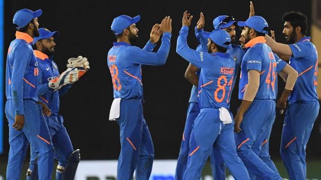 Indian cricket team players celebrate the wicket of Australia cricketer Usman Khawaja.(AFP)