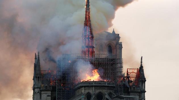 Smoke billows as fire engulfs the spire of Notre Dame Cathedral in Paris, France April 15, 2019. REUTERS/Benoit Tessier(REUTERS)