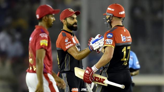 Mohali: Royal Challengers Bangalore (RCB) batsman Virat Kohli celebrates his fifty with AB de Villiers during the Indian Premier League (IPL T20 2019) cricket match between Royal Challengers Bangalore (RCB) and Kings XI Punjab( KXIP) at I S Bindra Stadium in Mohali, Saturday, April 13, 2019.(PTI) Mohali: Royal Challengers Bangalore (RCB) batsman Virat Kohli celebrates his fifty with AB de Villiers during the Indian Premier League (IPL T20 2019) cricket match between Royal Challengers Bangalore (RCB) and Kings XI Punjab( KXIP) at I S Bindra Stadium in Mohali, Saturday, April 13, 2019.(PTI)