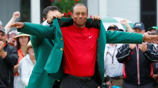 Patrick Reed places the green jacket on Tiger Woods of the U.S. after Woods won the 2019 Masters.(REUTERS)