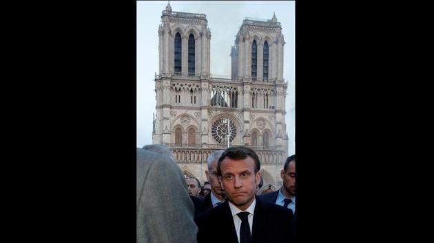 French President Emmanuel Macron walks near the Notre Dame Cathedral as its burns. Macron cancelled a planned policy speech and headed to the scene, where he vowed the cathedral would be reborn. “We will rebuild Notre-Dame because it is what the French expect,” he said, describing Notre Dame as “the epicentre of our life” and the cathedral of “all the French”, whether religious or not. (Philippe Wojazer / Pool / REUTERS) French President Emmanuel Macron walks near the Notre Dame Cathedral as its burns. Macron cancelled a planned policy speech and headed to the scene, where he vowed the cathedral would be reborn. “We will rebuild Notre-Dame because it is what the French expect,” he said, describing Notre Dame as “the epicentre of our life” and the cathedral of “all the French”, whether religious or not. (Philippe Wojazer / Pool / REUTERS)