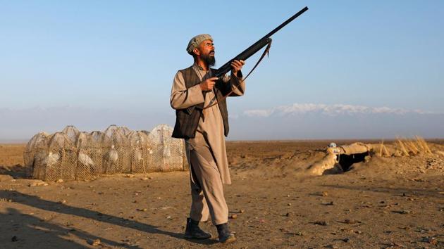 Jan Agha aims his gun at birds. The war has left much of the environment near Kabul devastated with uncleared mines, pollution, uncontrolled building and general neglect. Only in the last few years has there been an effort to restore areas like the former royal hunting grounds at Kol-e-Hashmat Khan in the city’s southwest. (Mohammad Ismail / REUTERS) Jan Agha aims his gun at birds. The war has left much of the environment near Kabul devastated with uncleared mines, pollution, uncontrolled building and general neglect. Only in the last few years has there been an effort to restore areas like the former royal hunting grounds at Kol-e-Hashmat Khan in the city’s southwest. (Mohammad Ismail / REUTERS)