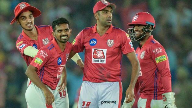 Kings XI Punjab bowler Murugan Ashwin (2L) celebrates with team captain Ravichandran Ashwin (C). (AFP)