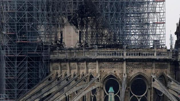View of Notre-Dame Cathedral after the fire. French billionaire Francois-Henri Pinault pledged 100 million euros ($113 million) on Monday towards the rebuilding of Notre Dame Cathedral. In a statement sent to AFP the CEO of the Kering group said the money towards “the effort necessary to completely rebuild Notre Dame” would be paid by the Pinault family’s investment firm Artemis. (Gonzalo Fuentes / REUTERS) View of Notre-Dame Cathedral after the fire. French billionaire Francois-Henri Pinault pledged 100 million euros ($113 million) on Monday towards the rebuilding of Notre Dame Cathedral. In a statement sent to AFP the CEO of the Kering group said the money towards “the effort necessary to completely rebuild Notre Dame” would be paid by the Pinault family’s investment firm Artemis. (Gonzalo Fuentes / REUTERS)