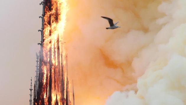 Gasps and cries of “Oh my god” erupted around an hour after the fire first broke out when the top portion of the church’s spire came crashing down. “We have been dealt a knockout blow,” a stricken-looking Paris Archbishop Michel Aupetit told reporters. (Benoit Tessier / REUTERS) Gasps and cries of “Oh my god” erupted around an hour after the fire first broke out when the top portion of the church’s spire came crashing down. “We have been dealt a knockout blow,” a stricken-looking Paris Archbishop Michel Aupetit told reporters. (Benoit Tessier / REUTERS)