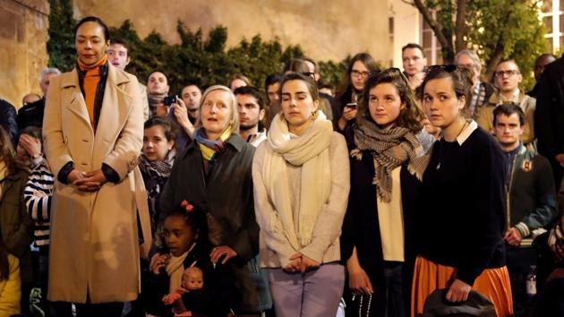People pray and sing religious songs next to Notre Dame Cathedral. “Notre-Dame survived all the wars, all the bombardments. We never thought it could burn. I feel incredibly sad and empty,” Stephane Seigneurie, a consultant who joined other shocked onlookers in a solemn rendition of “Ave Maria” as they watched the fire from a nearby bridge. (Charles Platiau / REUTERS) People pray and sing religious songs next to Notre Dame Cathedral. “Notre-Dame survived all the wars, all the bombardments. We never thought it could burn. I feel incredibly sad and empty,” Stephane Seigneurie, a consultant who joined other shocked onlookers in a solemn rendition of “Ave Maria” as they watched the fire from a nearby bridge. (Charles Platiau / REUTERS)