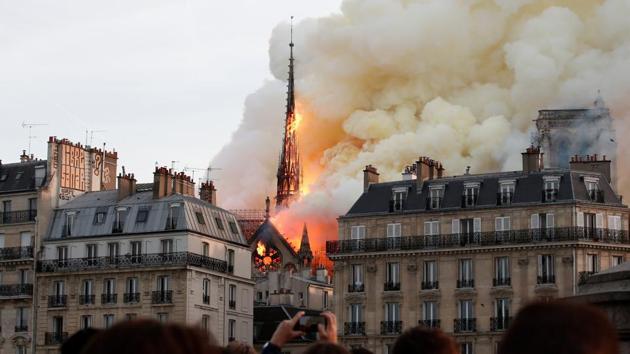 Smoke billows as fire engulfs the spire of Notre Dame Cathedral in Paris, France.(REUTERS)