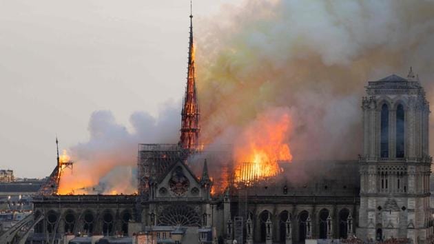 Smoke billows as flames burn through the roof of the Notre-Dame de Paris Cathedral on April 15, 2019, in the French capital Paris. Notre-Dame Cathedral went up in flames on Monday in a roaring blaze that devastated the Parisian landmark, one of France’s most visited places. Flames burst through the roof of the centuries-old cathedral and quickly engulfed the spire, which collapsed. (Fabien Barrau / AFP) Smoke billows as flames burn through the roof of the Notre-Dame de Paris Cathedral on April 15, 2019, in the French capital Paris. Notre-Dame Cathedral went up in flames on Monday in a roaring blaze that devastated the Parisian landmark, one of France’s most visited places. Flames burst through the roof of the centuries-old cathedral and quickly engulfed the spire, which collapsed. (Fabien Barrau / AFP)
