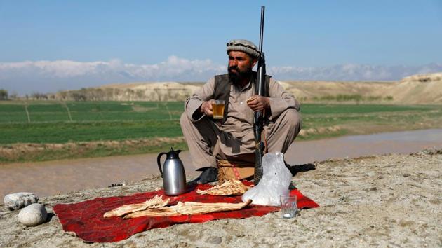 Jan Agha has breakfast at his hunting field in Bagram. “I have learned different types of hunting from my ancestors because they were hunters too,” said 49-year-old Jan Agha, a farmer in Parwan province. (Mohammad Ismail / REUTERS) Jan Agha has breakfast at his hunting field in Bagram. “I have learned different types of hunting from my ancestors because they were hunters too,” said 49-year-old Jan Agha, a farmer in Parwan province. (Mohammad Ismail / REUTERS)