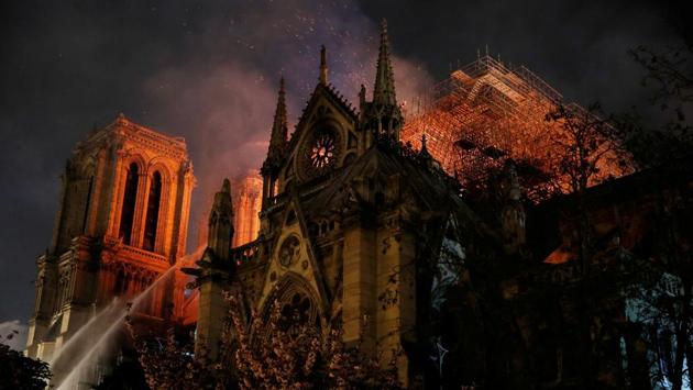 Sparks fill the air as Paris Fire brigade members spray water to extinguish flames. Paris prosecutor’s office says it has opened investigation for damage caused accidentally at fire at Paris’s Notre Dame Cathedral. (Philippe Wojazer / REUTERS) Sparks fill the air as Paris Fire brigade members spray water to extinguish flames. Paris prosecutor’s office says it has opened investigation for damage caused accidentally at fire at Paris’s Notre Dame Cathedral. (Philippe Wojazer / REUTERS)