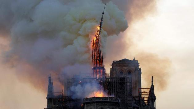 The church spire that extended 96-meters-high seen collapsing as the cathedral is engulfed in flames. The spire of Notre-Dame collapsed as a flames ravaged the roof of the famed gothic monument, deputy Paris mayor Emmanuel Gregoire told BFM TV, describing “colossal damage”. (Geoffroy Van Der Hasselt / AFP) The church spire that extended 96-meters-high seen collapsing as the cathedral is engulfed in flames. The spire of Notre-Dame collapsed as a flames ravaged the roof of the famed gothic monument, deputy Paris mayor Emmanuel Gregoire told BFM TV, describing “colossal damage”. (Geoffroy Van Der Hasselt / AFP)