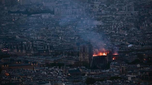 This general view taken from Montparnasse Tower shows the fire at Notre-Dame Cathedral in Paris. The cathedral was located at the centre of the French capital in the Middle Ages and its construction was completed in the mid-12th century after some 200 years of work. (Philippe Lopez / AFP) This general view taken from Montparnasse Tower shows the fire at Notre-Dame Cathedral in Paris. The cathedral was located at the centre of the French capital in the Middle Ages and its construction was completed in the mid-12th century after some 200 years of work. (Philippe Lopez / AFP)