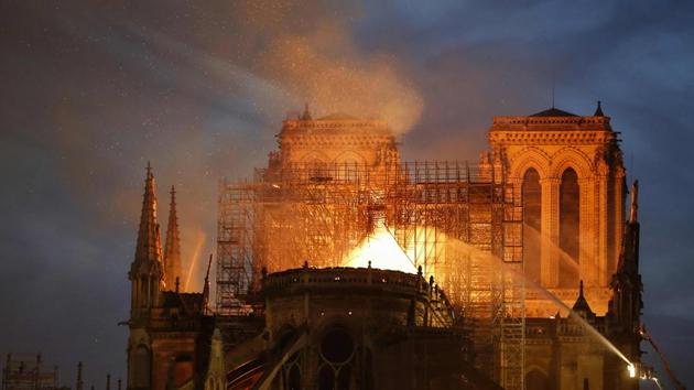 Firefighter douse flames billowing from the roof at Notre-Dame Cathedral. During the French Revolution in the 18th century, the cathedral was vandalised in widespread anti-Catholic violence: its spire was dismantled, its treasures plundered and its large statues at the grand entrance doors destroyed. (Francois Guillot / AFP) Firefighter douse flames billowing from the roof at Notre-Dame Cathedral. During the French Revolution in the 18th century, the cathedral was vandalised in widespread anti-Catholic violence: its spire was dismantled, its treasures plundered and its large statues at the grand entrance doors destroyed. (Francois Guillot / AFP)