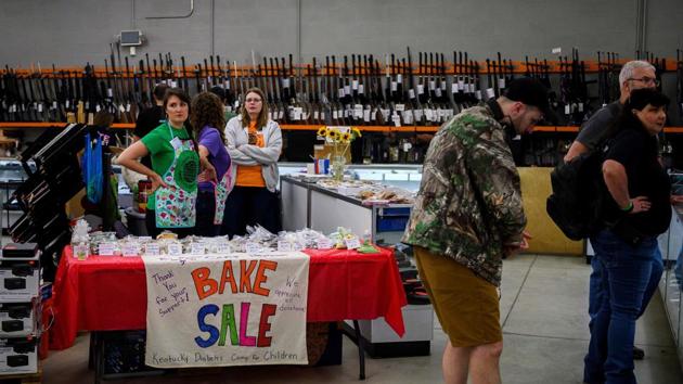 Women running a bake sale wait for customers inside the Knob Creek gun shop. “You can shoot anything that goes bang if you got enough money for rental,” said Winters. (Andrew Caballero-Reynolds / AFP)
