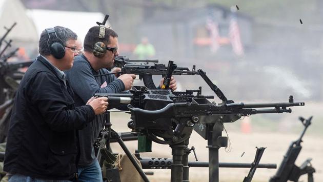 People fire machine guns on the main firing line. “This is a place to come compete and have fun with your buddies,” Winters said. (Andrew Caballero-Reynolds / AFP)