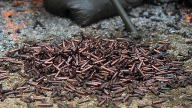Spent shells are seen at the base of a machine gun on the main firing line during a break in the shooting. Visitors who don’t own a weapon can rent a machine gun -- cash only -- if they sign a waiver and are over 18 years old. (Andrew Caballero-Reynolds / AFP)
