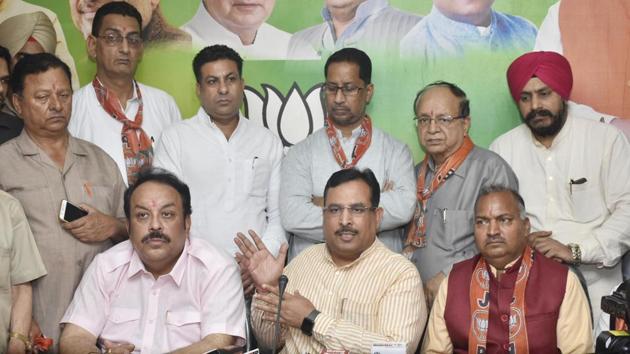 Haryana finance minister Captain Abhimanyu (Centre), BJP Punjab president Shwait Malik (left) and others addressing a press conference in Amritsar on Wednesday.(HT Photo)