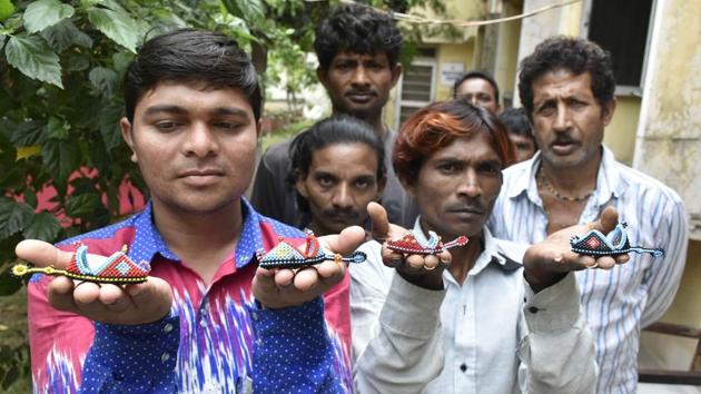 Indian fishermen show shoes made by them in Pakistan jails, after being repatriated to India, Amritsar, April 16, 2019.(Sameer Sehgal / HT Photo)