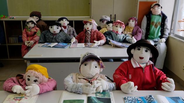 The secret to breathing life into the dolls? Applying pink colour to the lips and cheeks with a make-up brush, revealed Ayano. At the local school, she has placed 12 colourful child-sized dolls at desks, positioned as if part of a lively class poring over their books. The school closed seven years ago as there was no one left to teach, she recalled sadly. (Kazuhiro Nogi / AFP) 