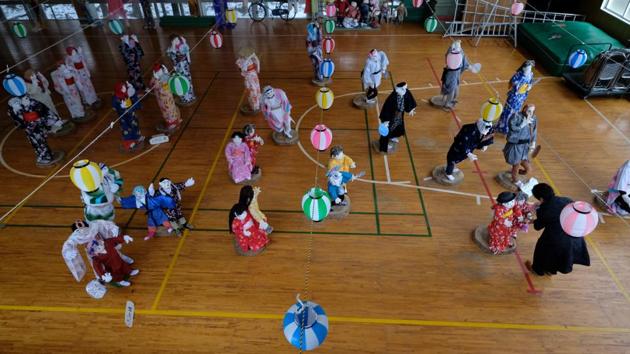 Ayano (bottom R) inspects her dolls at an elementary school. Prime Minister Shinzo Abe has pledged to revive regions outside Tokyo by pumping in tens of billions of yen, but this isn’t enough to stop young people from leaving hometowns, Fujinami said. “In order to combat depopulation, we need people moving in to depopulated areas. But recovering the population is extremely difficult.” (Kazuhiro Nogi / AFP) 