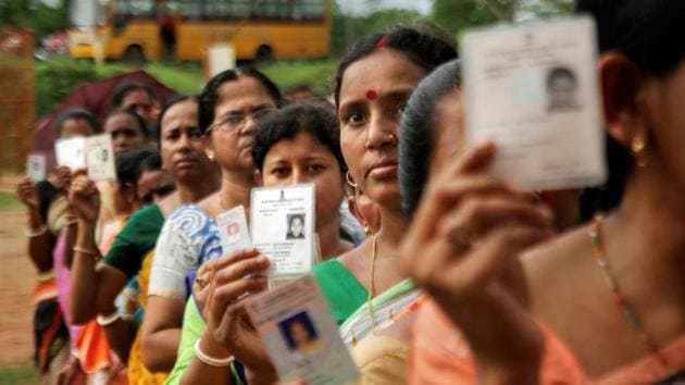 Agartala: Women show their voter identity cards as they stand in a queue before casting their votes during the first phase of the general elections, at a polling station in Agartala, Tripura, Thursday, April 11, 2019. (PTI Photo)(PTI4_11_2019_000055B)(PTI)