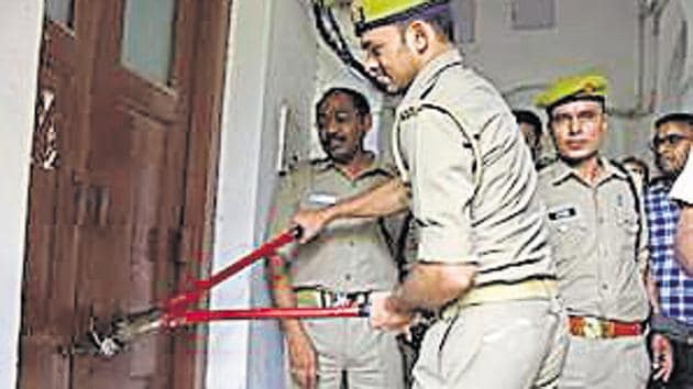 Police breaking locks of rooms at a hostel of the Allahabad University.(HT Photo)