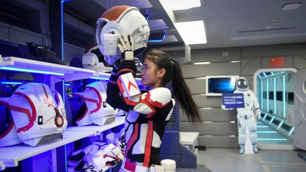 A guide puts on a spacesuit at the base. As budding astronauts explore “Mars” on Earth, China is planning to send a probe to the real Red Planet next year. Beijing is pouring billions into its military-run space programme, with hopes of having a crewed space station by 2022. Earlier this year, it made the first ever soft landing on the far side of the moon, deploying a rover. (Wang Zhao / AFP)