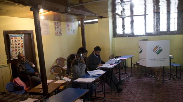 Election officers sit inside an empty polling station during in Srinagar. Kashmiri separatist leaders who challenge India’s sovereignty over the disputed region have called for a boycott of the vote. People voted in large numbers in Jammu and Kashmir’s Udhampur Lok Sabha seat but polling was muted in the Srinagar Lok Sabha constituency. (Dar Yasin / AP)