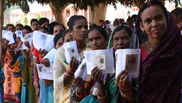 Voters show their identity cards as they stand in queues to cast their votes during the second phase of the general elections at a polling station, in Kandhamal district, Odisha, India, April 18, 2019.(HT file photo)