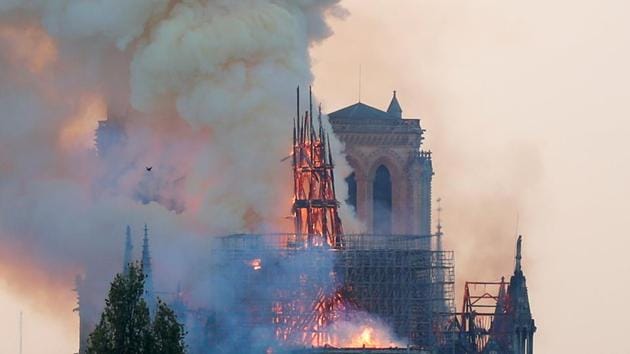 Smoke rises from the burning spire on the roof at the Notre-Dame?Cathedral after a fire broke out, in Paris, France April 15, 2019. Picture taken April 15, 2019. REUTERS/Charles Platiau - RC198DB5D280(REUTERS)