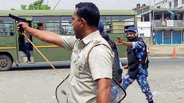 Security personnel try to control a mob during the second phase of LS polls, in West Bengal’s North Dinajpur district on Thursday (PTI) Security personnel try to control a mob during the second phase of LS polls, in West Bengal’s North Dinajpur district on Thursday (PTI)