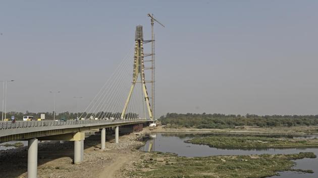 Even five months after construction, debris, which has not been removed, is choking the flow of the river Yamuna.(Sanchit Khanna/HT PHOTO)