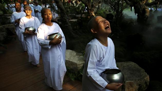 Novice nuns walk in line to receive food from people during the Songkran Festival at the Sathira-Dhammasathan Buddhist meditation centre in Bangkok, Thailand. (Athit Perawongmetha / REUTERS) 