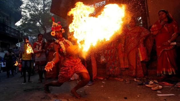 A man throws fire towards the gate of a temple as part of a ritual ending a religious procession held to mark the Gajan festival in Kolkata, West Bengal. (Rupak De Chowdhuri / REUTERS) A man throws fire towards the gate of a temple as part of a ritual ending a religious procession held to mark the Gajan festival in Kolkata, West Bengal. (Rupak De Chowdhuri / REUTERS)
