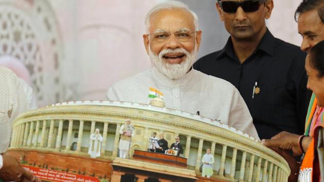 Prime Minister Narendra Modi being presented a memento during an election campaign meeting for the Lok Sabha elections in Amreli, Gujarat. (PTI) Prime Minister Narendra Modi being presented a memento during an election campaign meeting for the Lok Sabha elections in Amreli, Gujarat. (PTI)