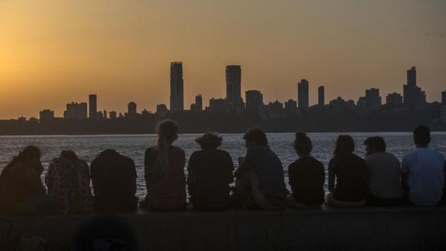 People sit and watch sunset by the Marine Drive in Mumbai, Maharashtra. (Pratik Chorge / HT Photo) People sit and watch sunset by the Marine Drive in Mumbai, Maharashtra. (Pratik Chorge / HT Photo)