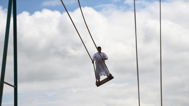 A youth plays on a swing at a playground in Mazar-i-Sharif, Afghanistan. (Farshad Usyan / AFP) 