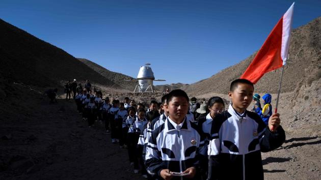 The teenagers go on treks in the desert, where they explore caves in the martian-like landscape. The closest town 40 kilometres away. On Wednesday, over 100 students from a nearby high school walked on the arid Gobi plains, dressed in spacesuit-esque tracksuits. “There are so many things here that I’ve not seen before, I’m very interested in it,” said 12-year old Tang Ruitian. (Wang Zhao / AFP)