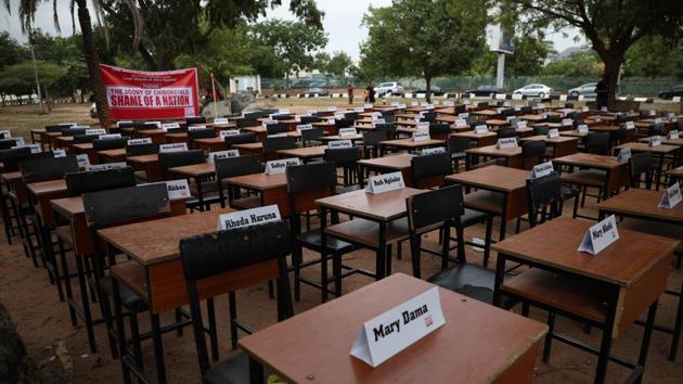 Names of the remaining Chibok schoolgirls are displayed with their desk during the 5th Year Commemoration of the abduction of the 276 Chibok Schoolgirls by Boko Haram on April 14, 2014 from Government Secondary School, Chibok, Borno State, Nigeria. (Kola Sulaimon / AFP) 